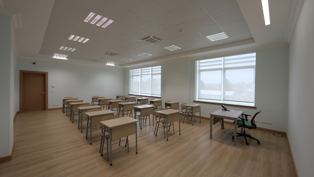 Classroom space with chairs, desks for students and task chair