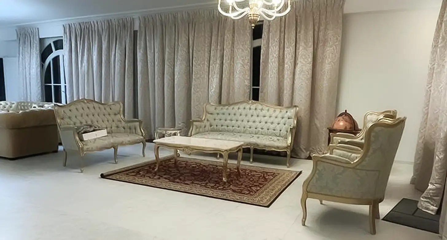 Living room at Embassy Residency, Brussels, Belgium, featuring white rug and chairs.