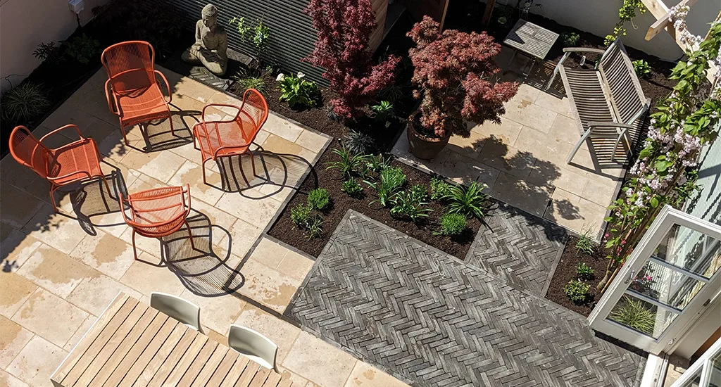 Aerial view of a London residential patio adorned with chairs and plants, creating a serene outdoor space.